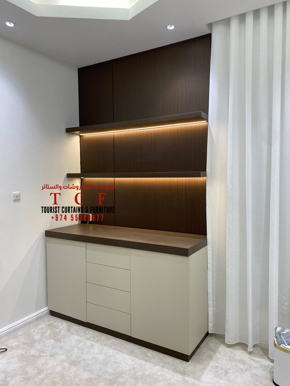 Custom TV cabinet with warm lighting and sheer curtains